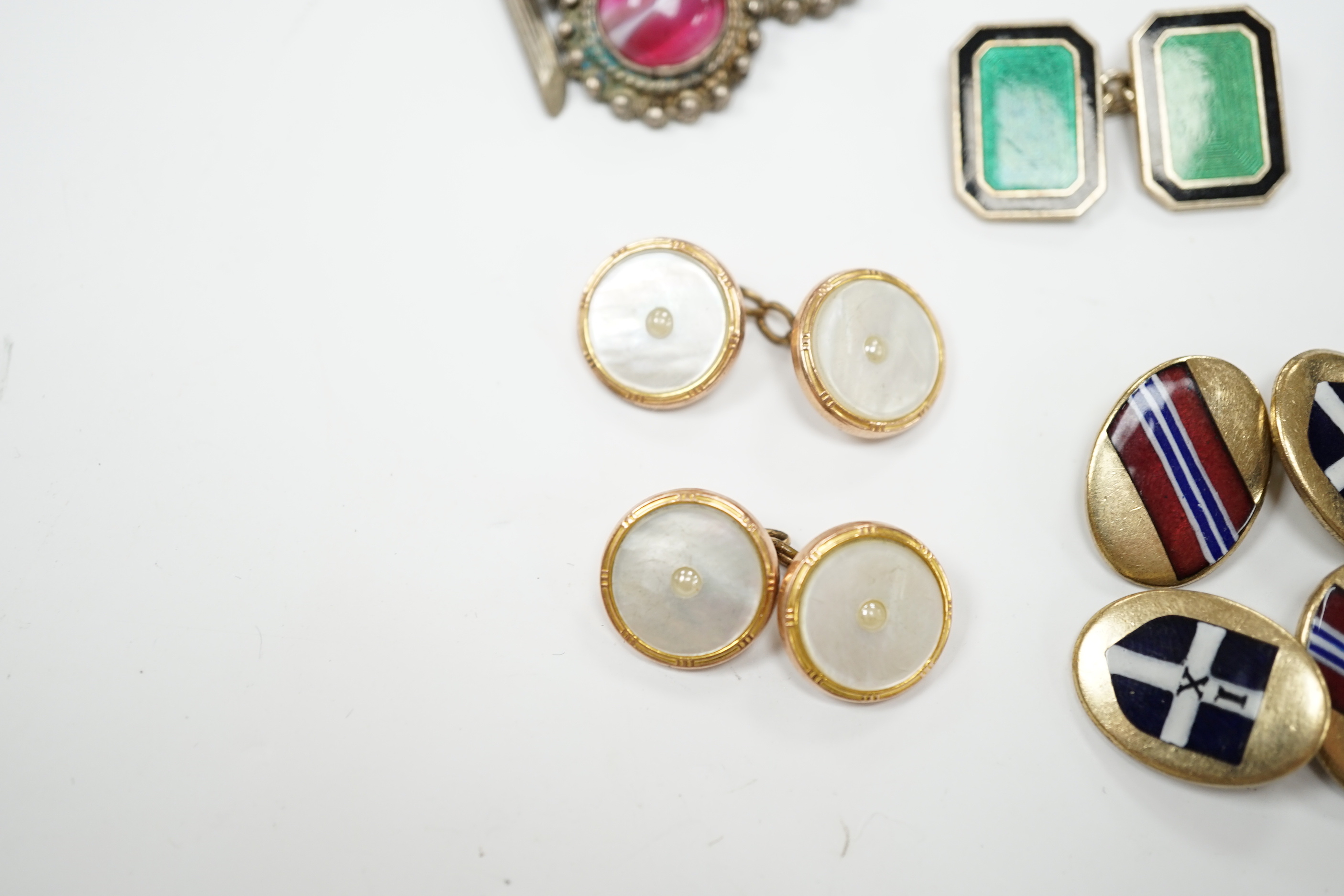 Four assorted pairs of cufflinks including silver and two coloured enamel.